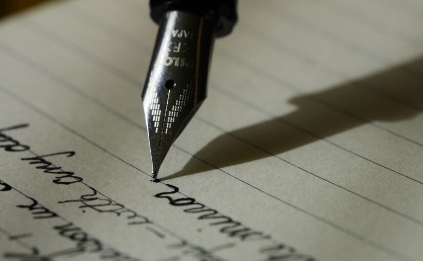 fountain pen on black lined paper